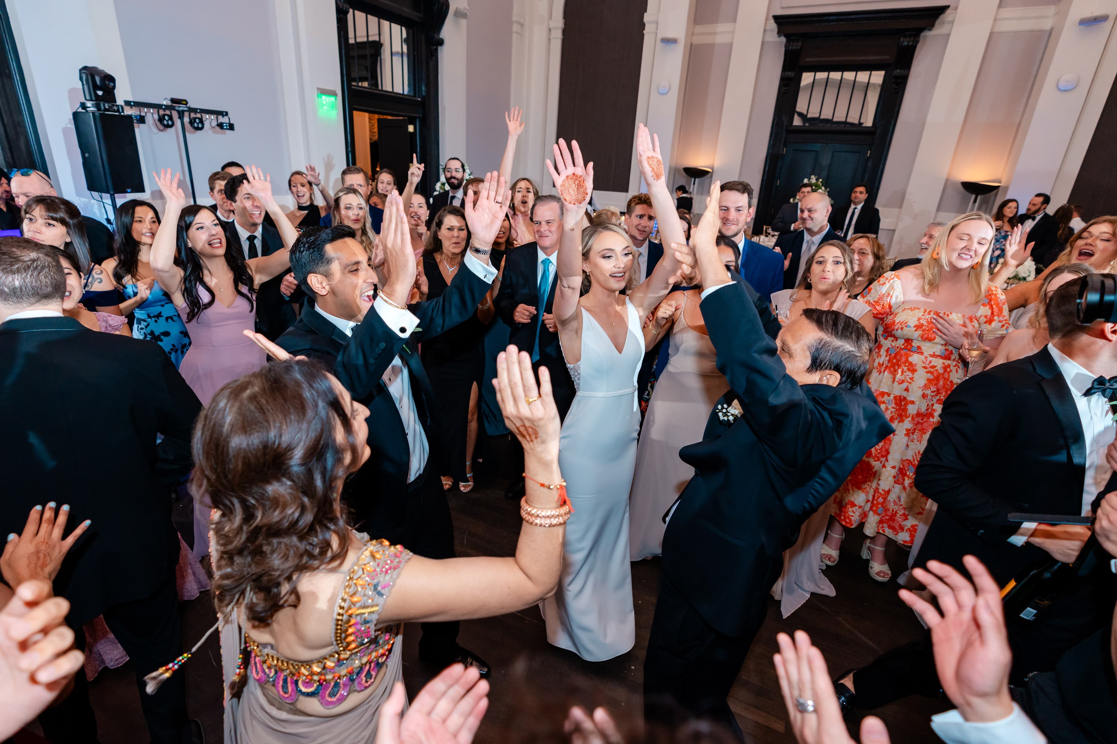 Bride and bridesmaids dancing with purple uplighting
