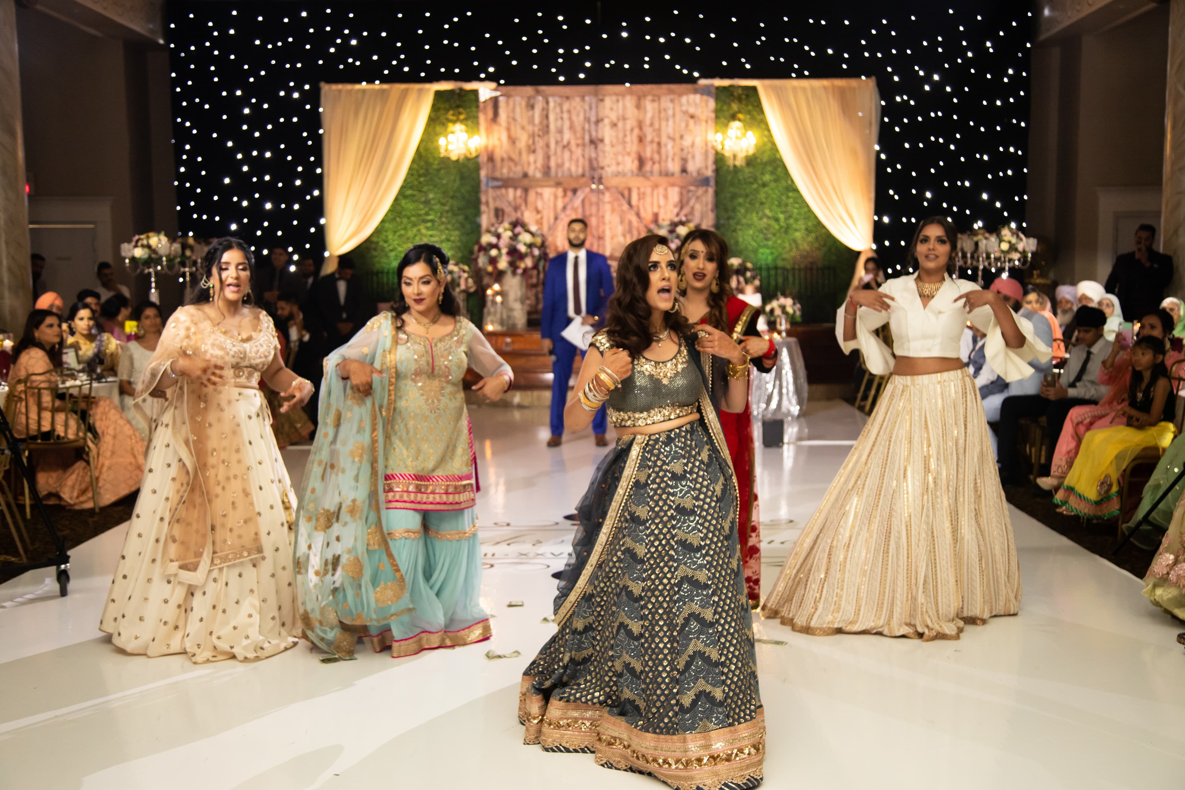 Ornate ballroom dhol dancing at sangeet
