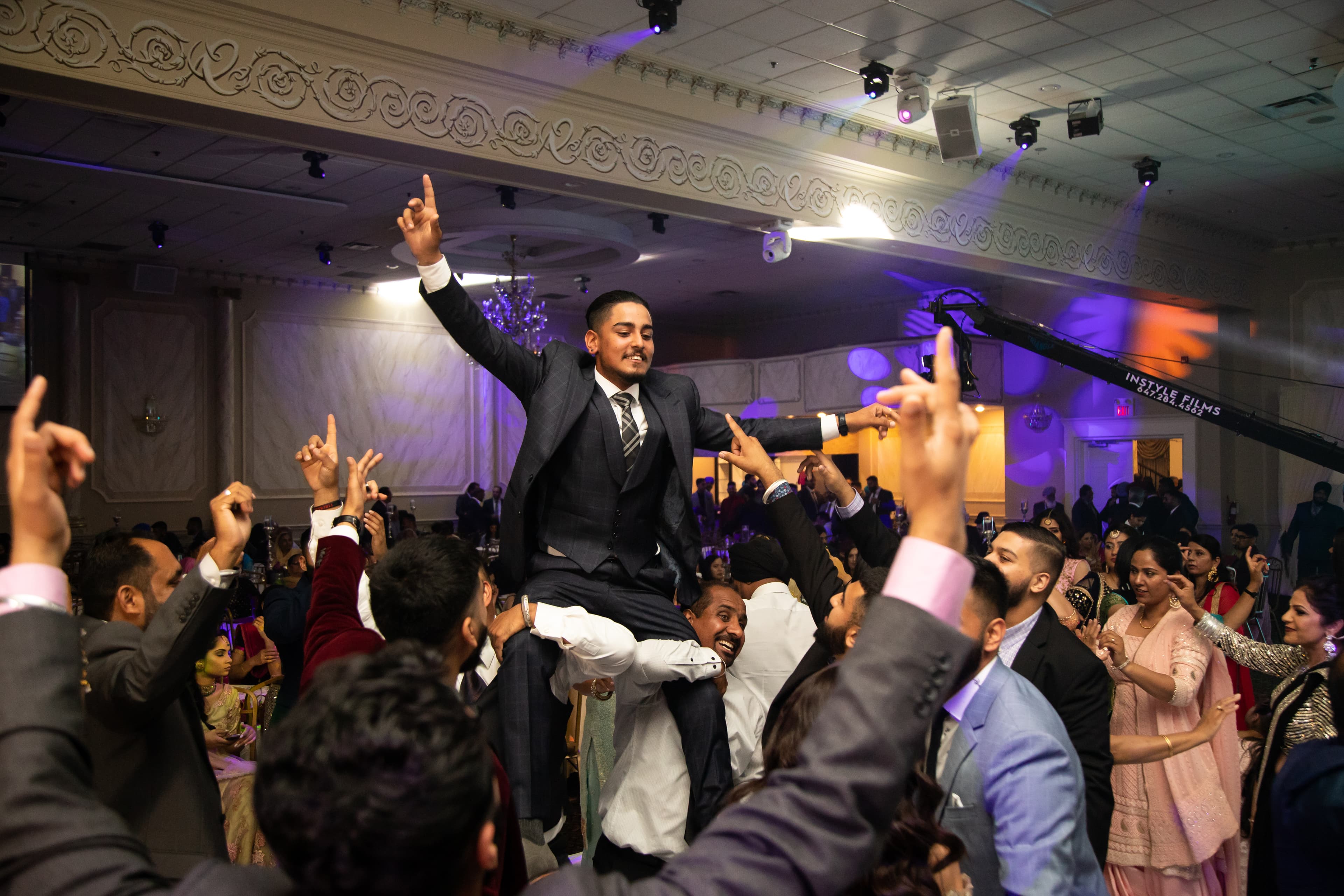 Hartaj playing dhol at wedding reception with high energy crowd