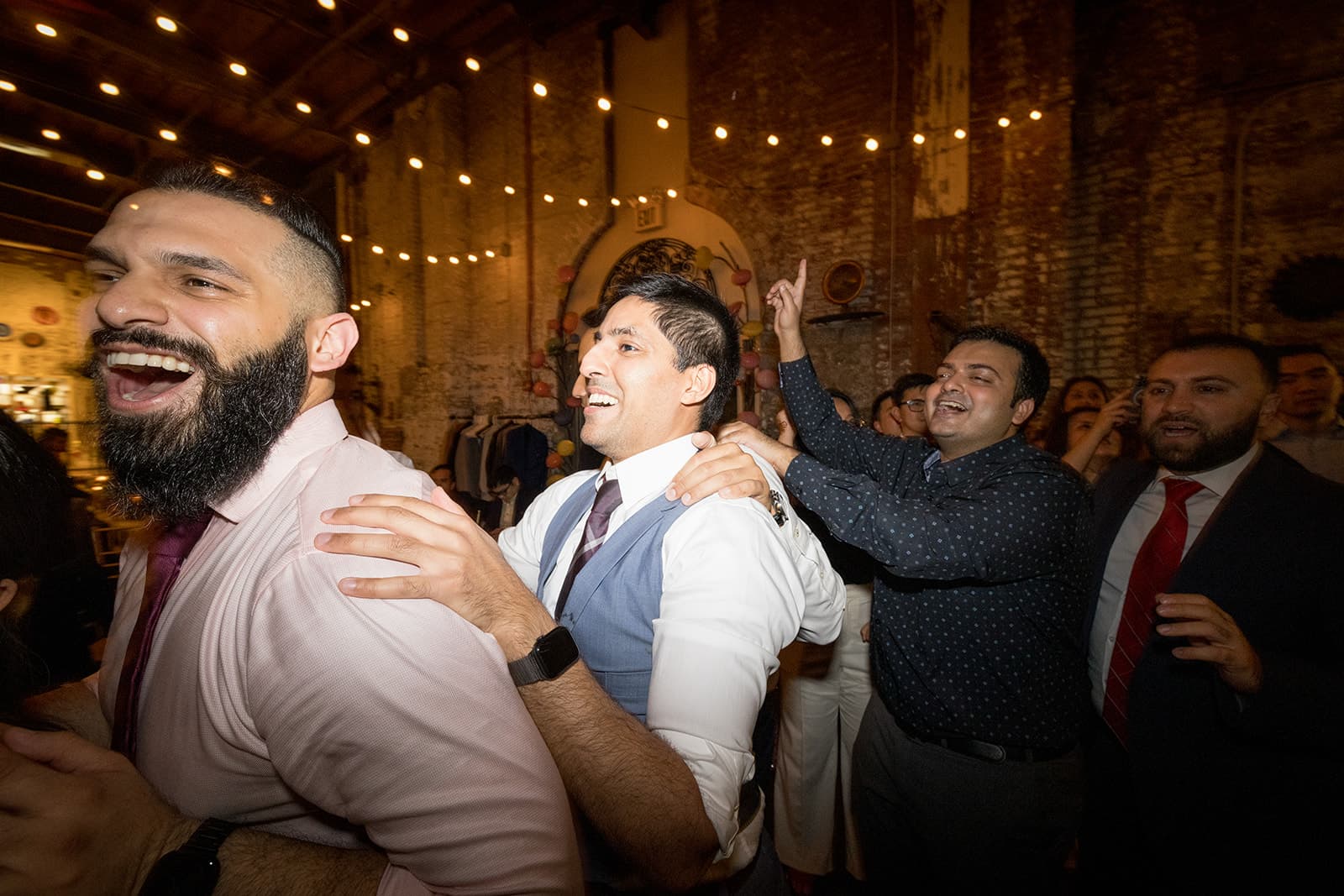 Crowd dancing under DJ lighting at a special event