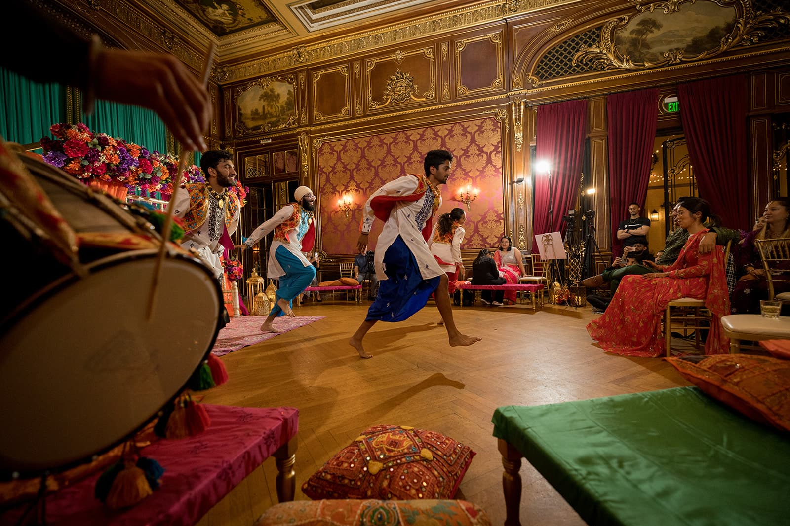 Ornate ballroom dhol dancing at sangeet